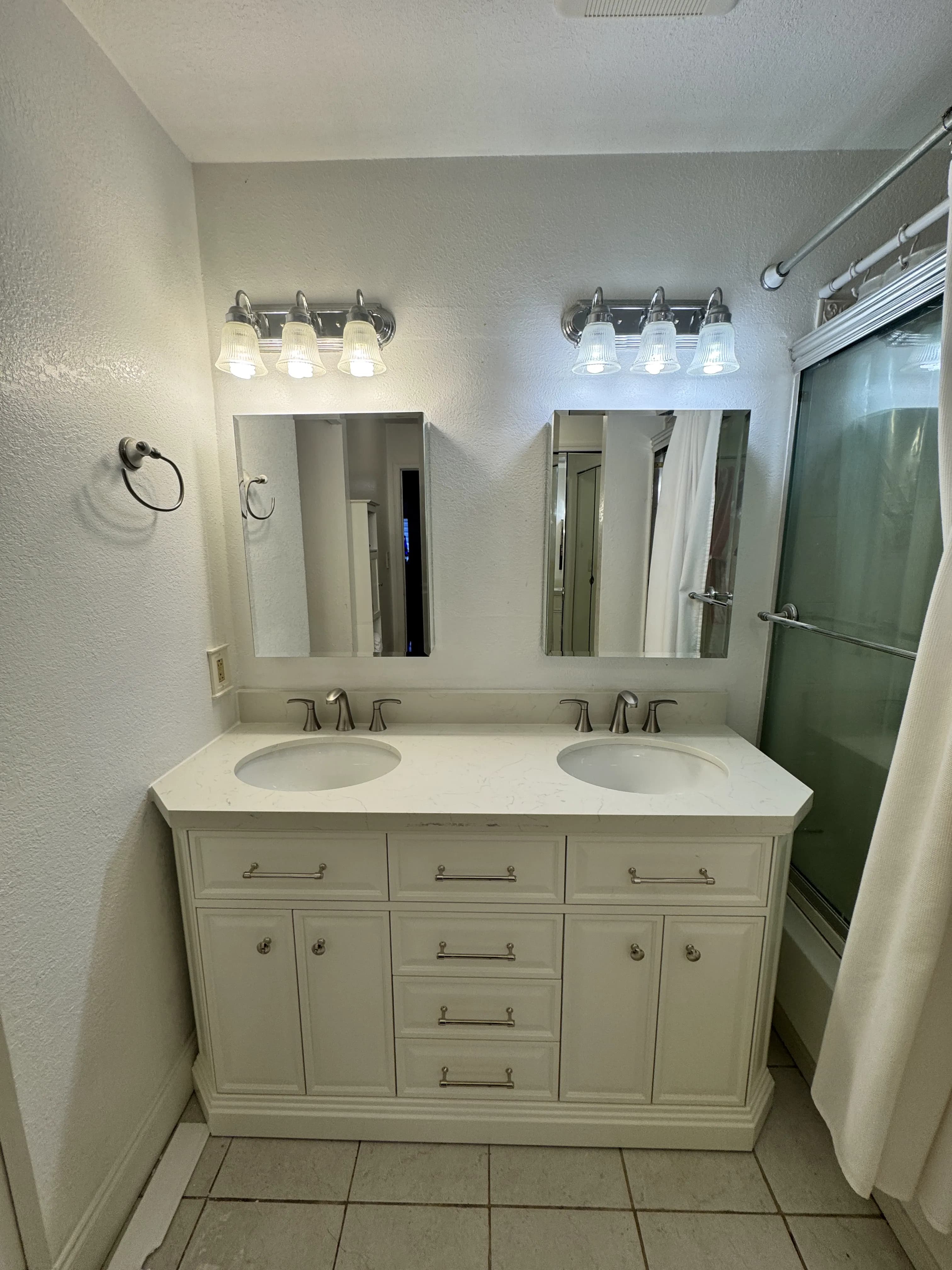 Updated bathroom with double vanity and mirrors